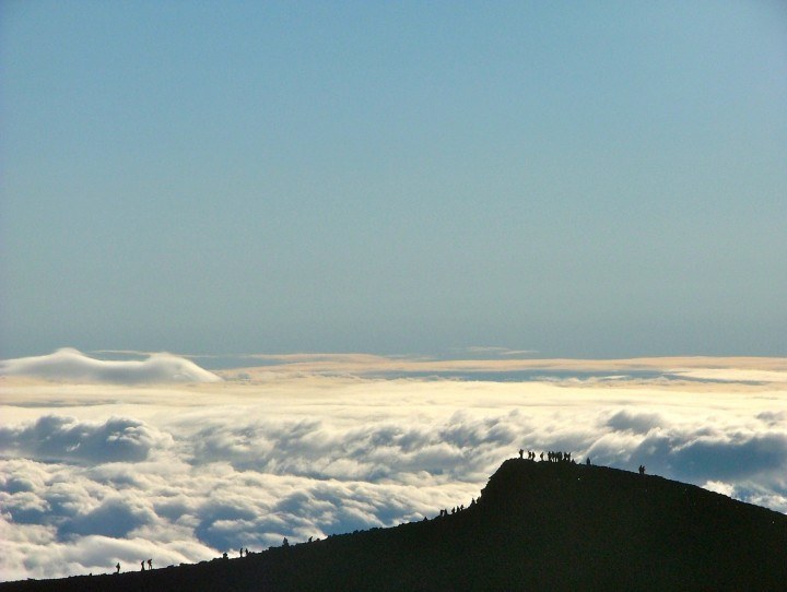 Clouds in the background with hikers on top of Mount Fuji