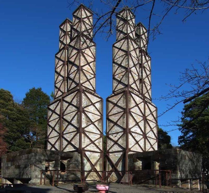 Four big chimneys rise up to the blue skies